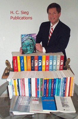 Herb Sieg standing behind a table lined with the accounting and tax textbooks he wrote and contributed to.